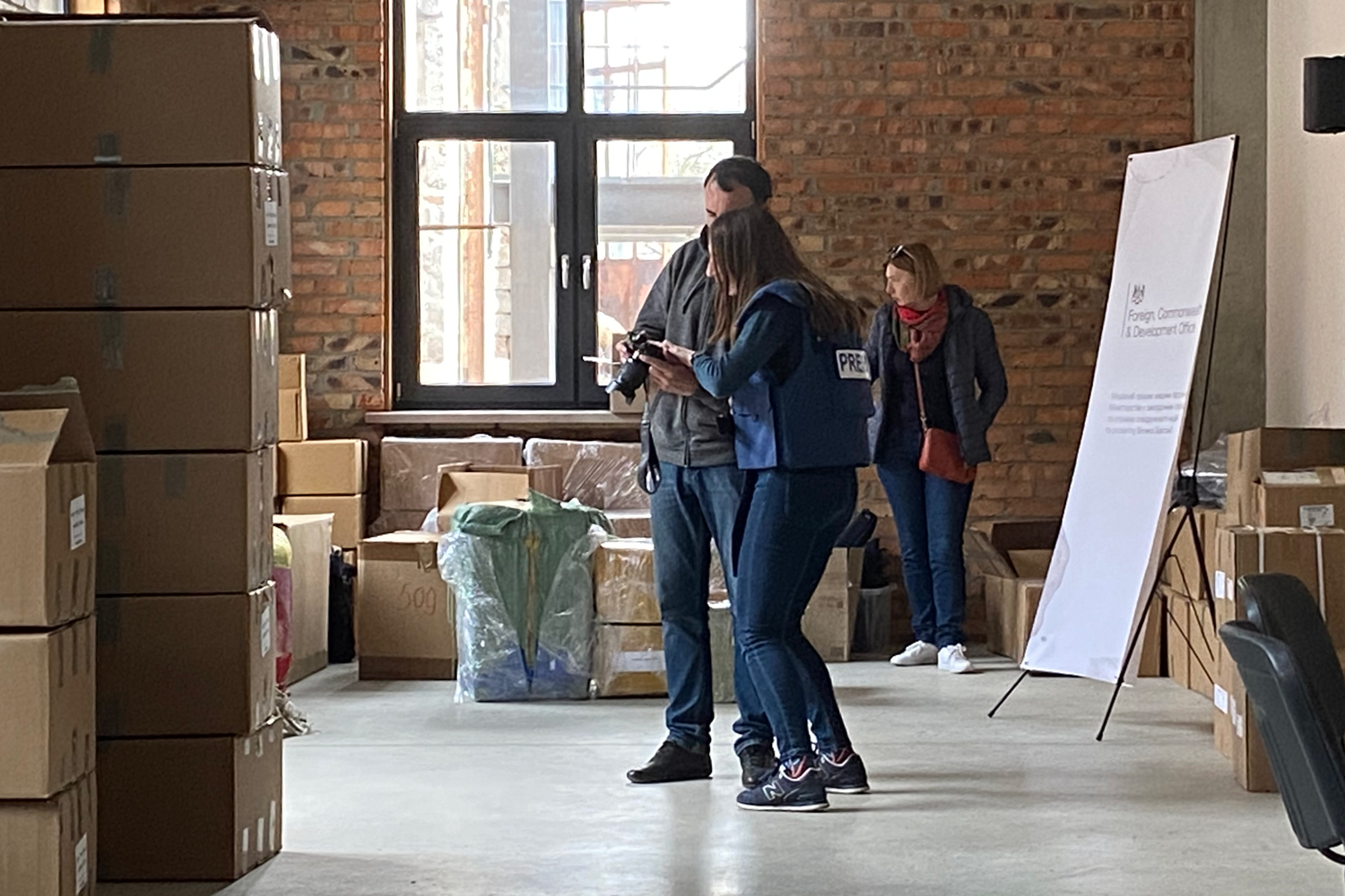 Two people looking at professional camera