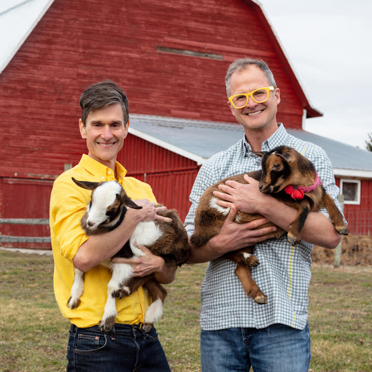 The founders of Beekman 1802 holding baby goats on a farm with the statistic ‘400% ROI in 2021’.